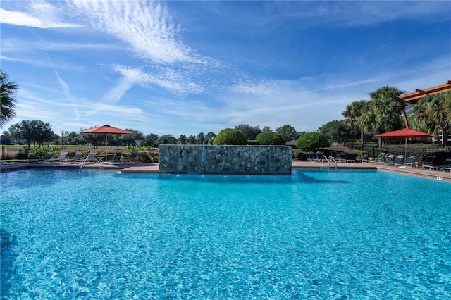 view of swimming pool with pool water feature