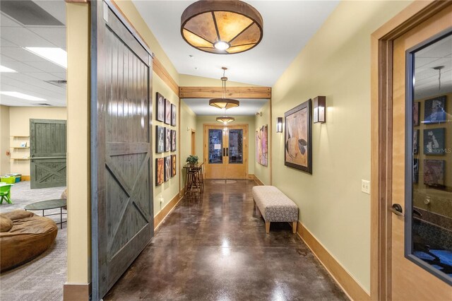 hall featuring french doors and lofted ceiling