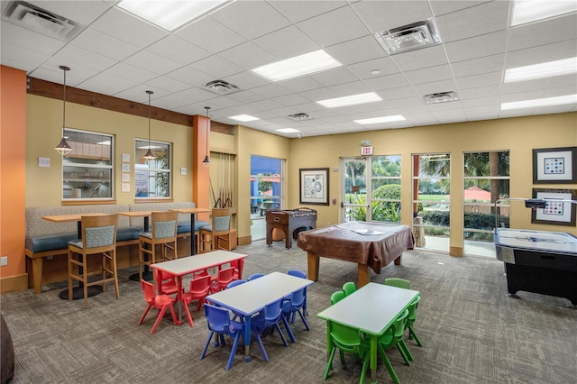 recreation room featuring a paneled ceiling and carpet flooring