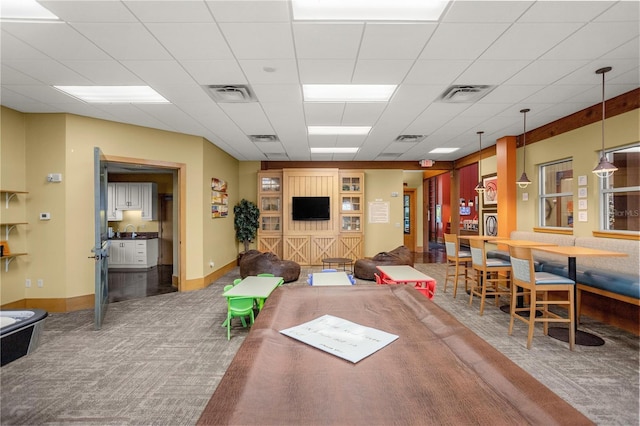 interior space featuring a drop ceiling, sink, and carpet flooring