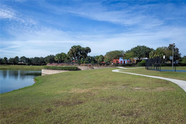 view of community with a yard and a water view
