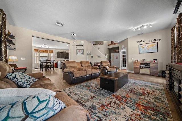 living room with hardwood / wood-style flooring and a textured ceiling