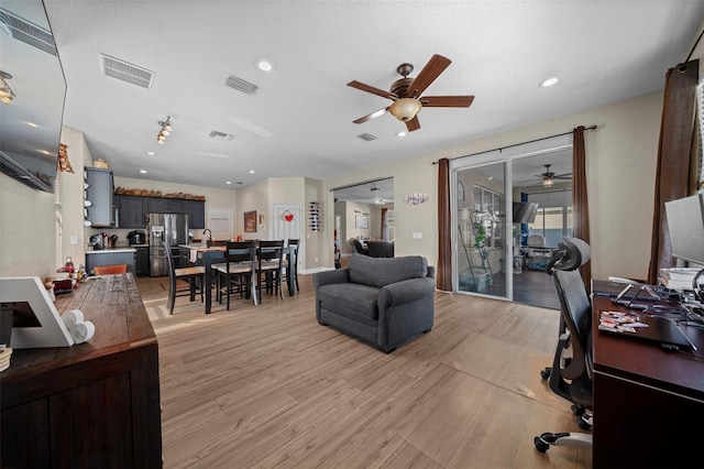 office area with ceiling fan and light hardwood / wood-style floors