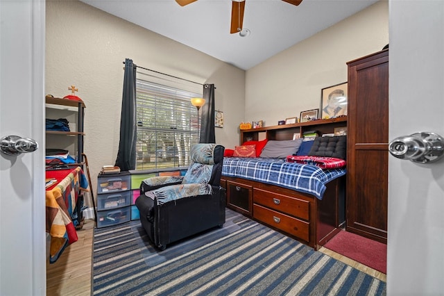 bedroom with ceiling fan and wood-type flooring