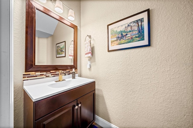 bathroom featuring tasteful backsplash and vanity