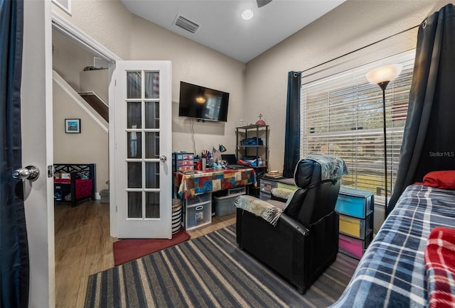 bedroom with dark hardwood / wood-style flooring