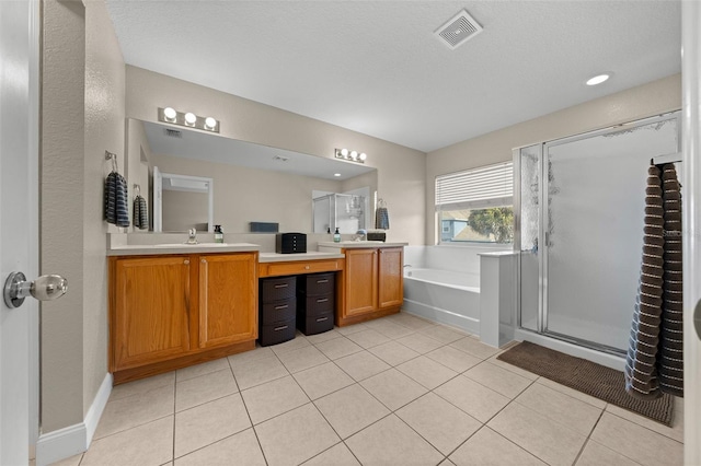 bathroom with vanity, tile patterned floors, a textured ceiling, and plus walk in shower