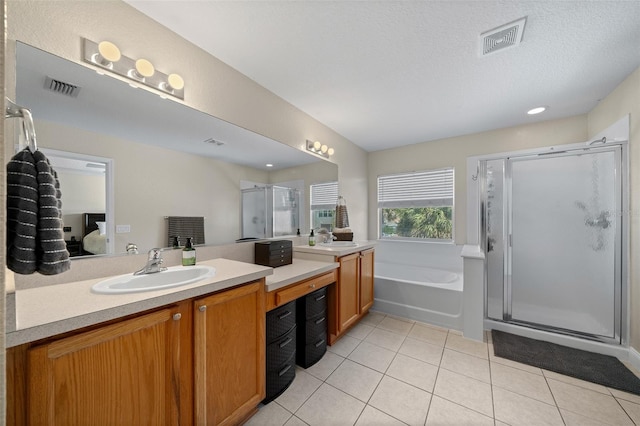 bathroom featuring tile patterned flooring, vanity, and independent shower and bath