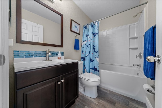 full bathroom featuring vanity, hardwood / wood-style floors, shower / tub combo with curtain, and toilet