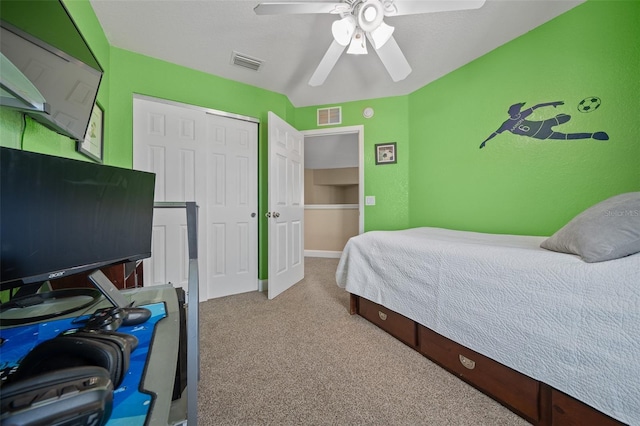 bedroom with light carpet, a closet, and ceiling fan