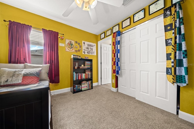 carpeted bedroom featuring a closet and ceiling fan