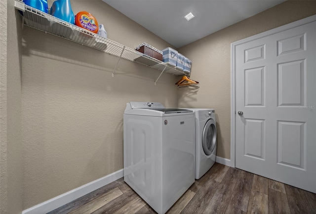 clothes washing area with washing machine and dryer and hardwood / wood-style floors