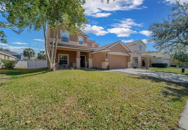 view of front of home with a garage, a front yard, and covered porch