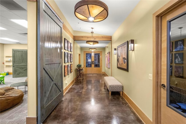 hall featuring french doors, a paneled ceiling, and vaulted ceiling