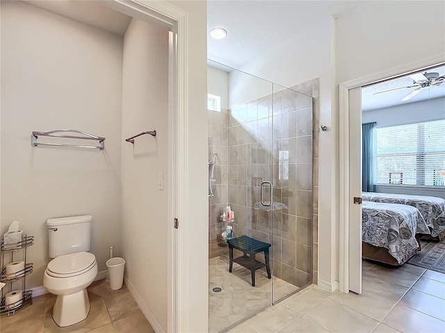 bathroom with ceiling fan, toilet, a shower with door, and tile patterned flooring