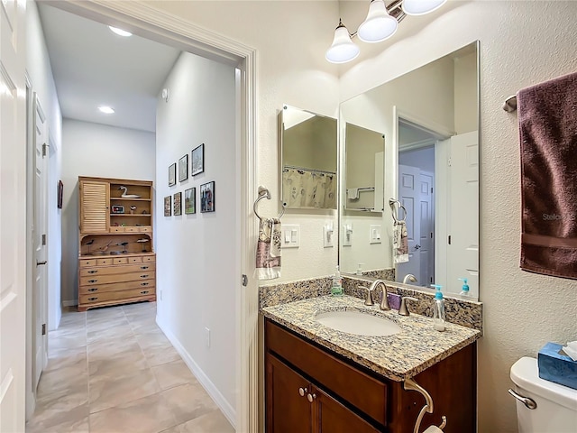 bathroom featuring vanity and toilet