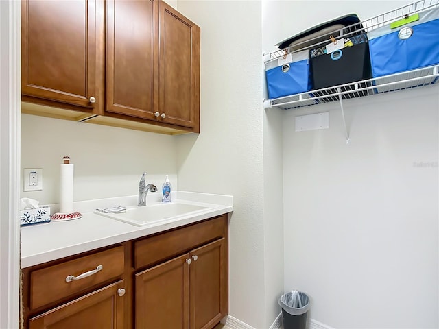 clothes washing area featuring sink