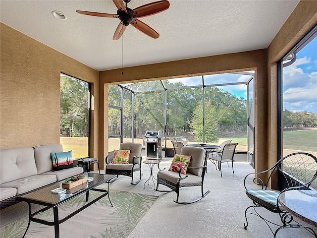 sunroom / solarium featuring ceiling fan