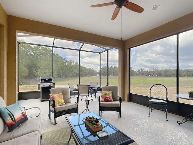 sunroom / solarium featuring ceiling fan