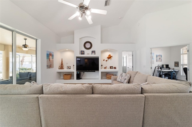 living room featuring built in shelves, high vaulted ceiling, and ceiling fan