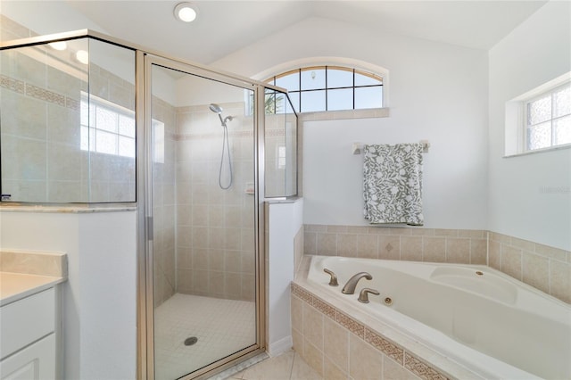 bathroom featuring vanity, separate shower and tub, and lofted ceiling