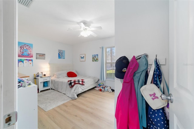 bedroom with hardwood / wood-style flooring and ceiling fan