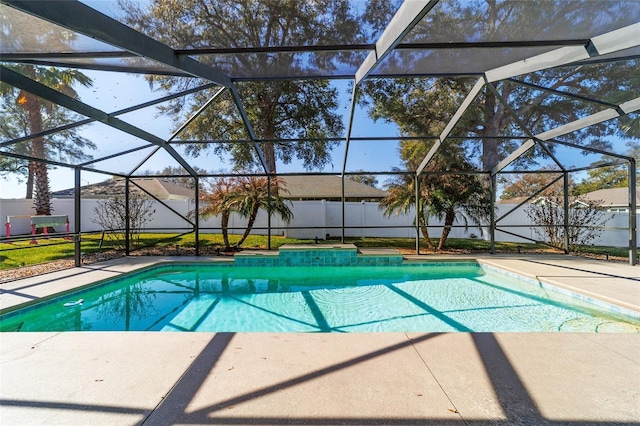 view of swimming pool with a patio area and glass enclosure