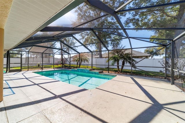 view of swimming pool with a patio and glass enclosure