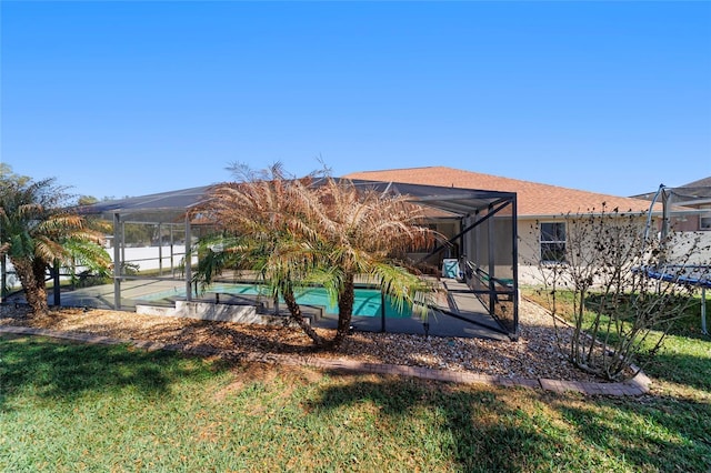 exterior space featuring a lanai and a yard