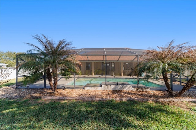 view of pool featuring glass enclosure