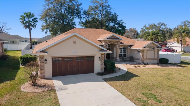 view of front of home with a garage and a front yard