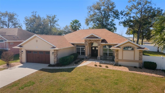 single story home featuring a garage and a front lawn