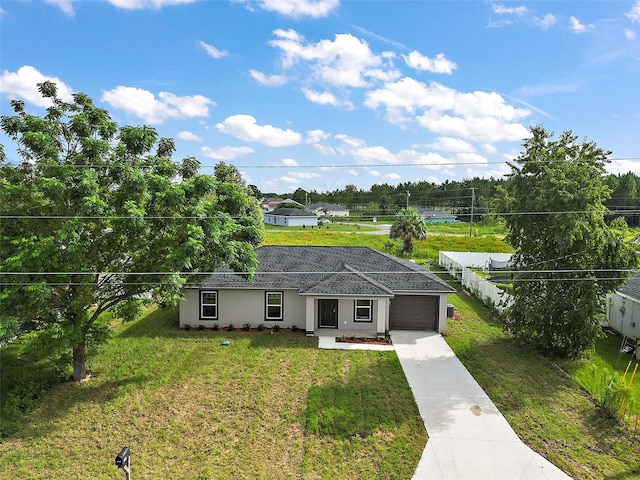 single story home featuring a garage and a front yard