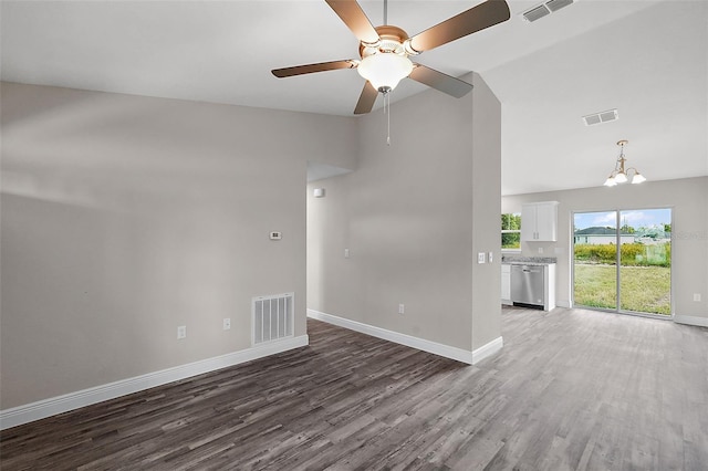 spare room featuring wood-type flooring, lofted ceiling, and ceiling fan with notable chandelier
