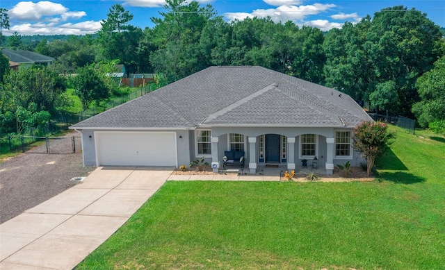 view of front of home featuring a garage, a front yard, and covered porch