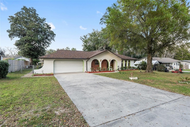 view of front of house featuring a garage and a front lawn