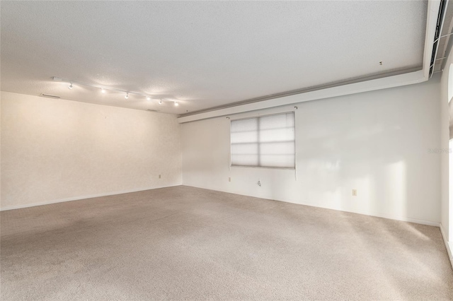 carpeted spare room featuring a textured ceiling