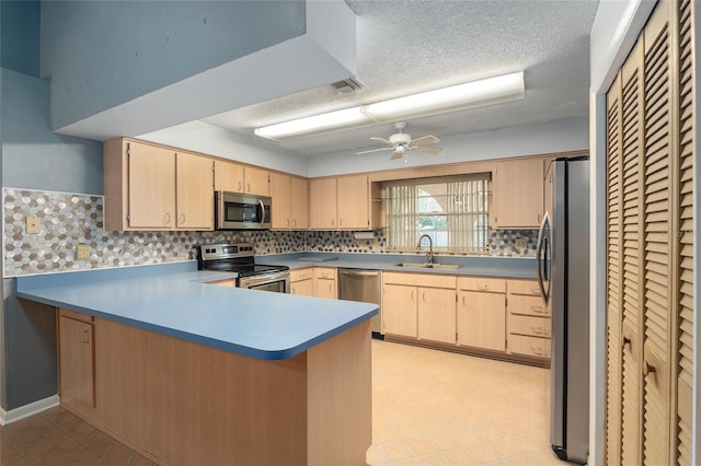 kitchen featuring sink, ceiling fan, kitchen peninsula, stainless steel appliances, and light brown cabinets