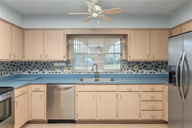 kitchen with stainless steel appliances, tasteful backsplash, sink, and light brown cabinets