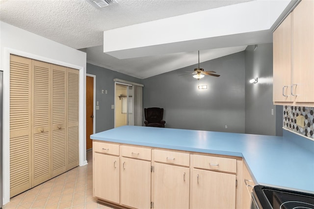 kitchen featuring vaulted ceiling, electric range, light brown cabinets, kitchen peninsula, and ceiling fan