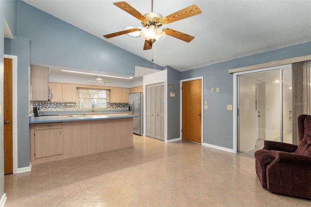 kitchen with ceiling fan, stainless steel appliances, decorative backsplash, kitchen peninsula, and light brown cabinets