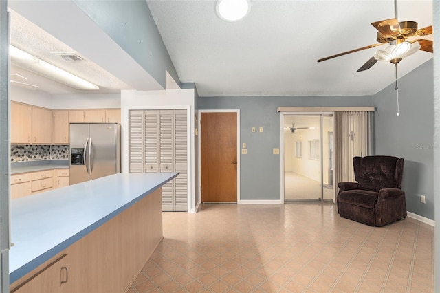 kitchen featuring backsplash, ceiling fan, stainless steel fridge, and light brown cabinets