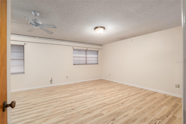 unfurnished room featuring ceiling fan, a textured ceiling, and light wood-type flooring