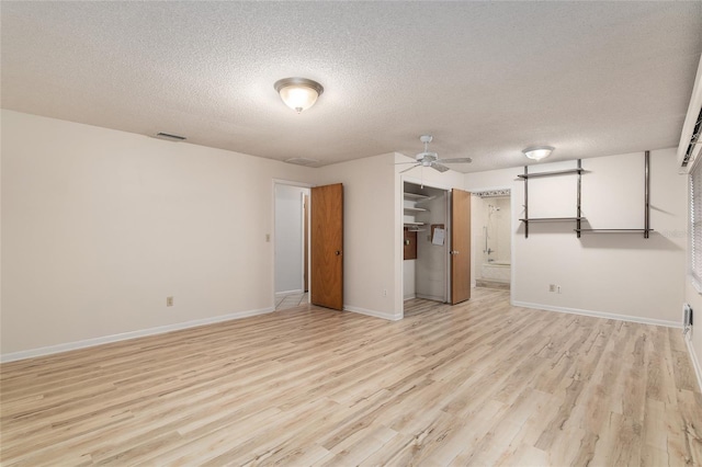 interior space featuring ceiling fan, light hardwood / wood-style flooring, and a textured ceiling