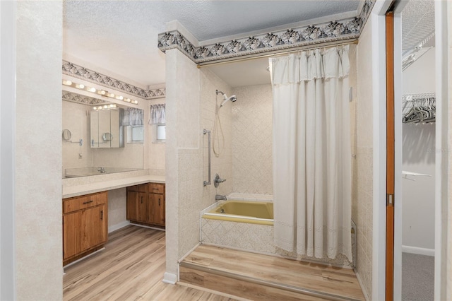 bathroom with vanity, shower / tub combo, hardwood / wood-style floors, and a textured ceiling