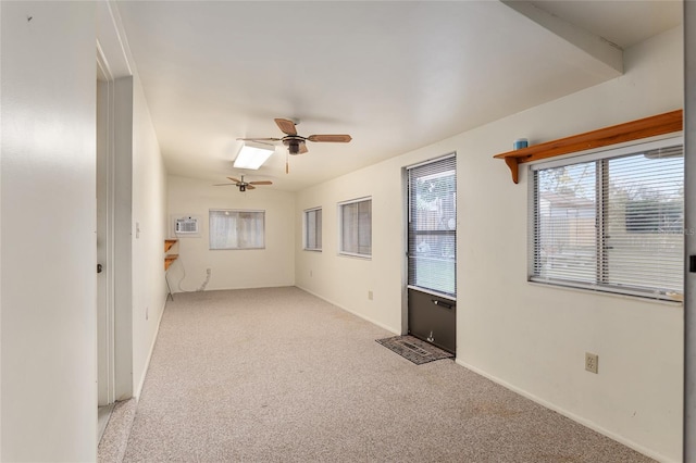 carpeted empty room with ceiling fan and an AC wall unit