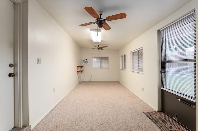 unfurnished room featuring light carpet, a wall mounted air conditioner, and ceiling fan