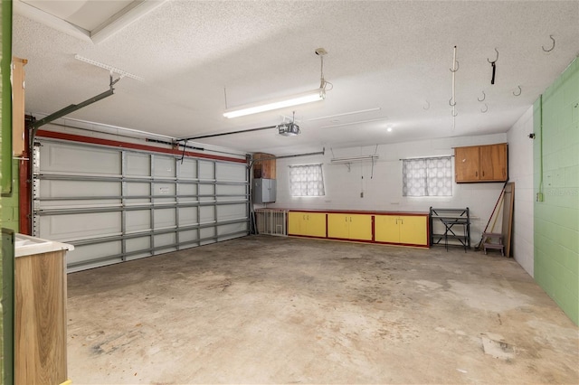 garage with a garage door opener and electric panel