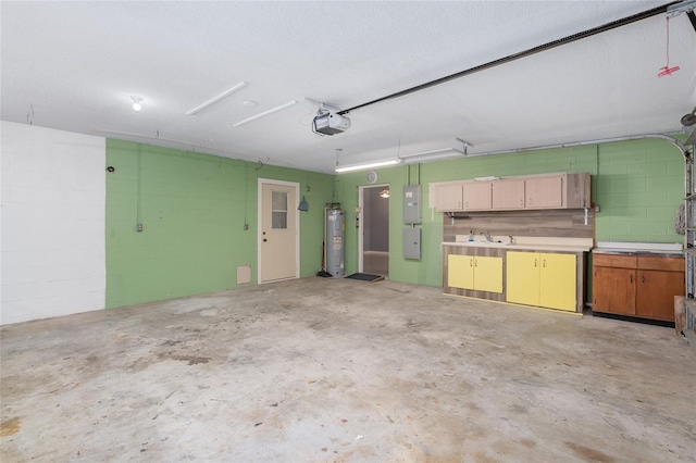 garage featuring sink, a garage door opener, electric panel, and water heater