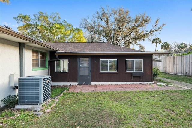 exterior space featuring cooling unit and a lawn